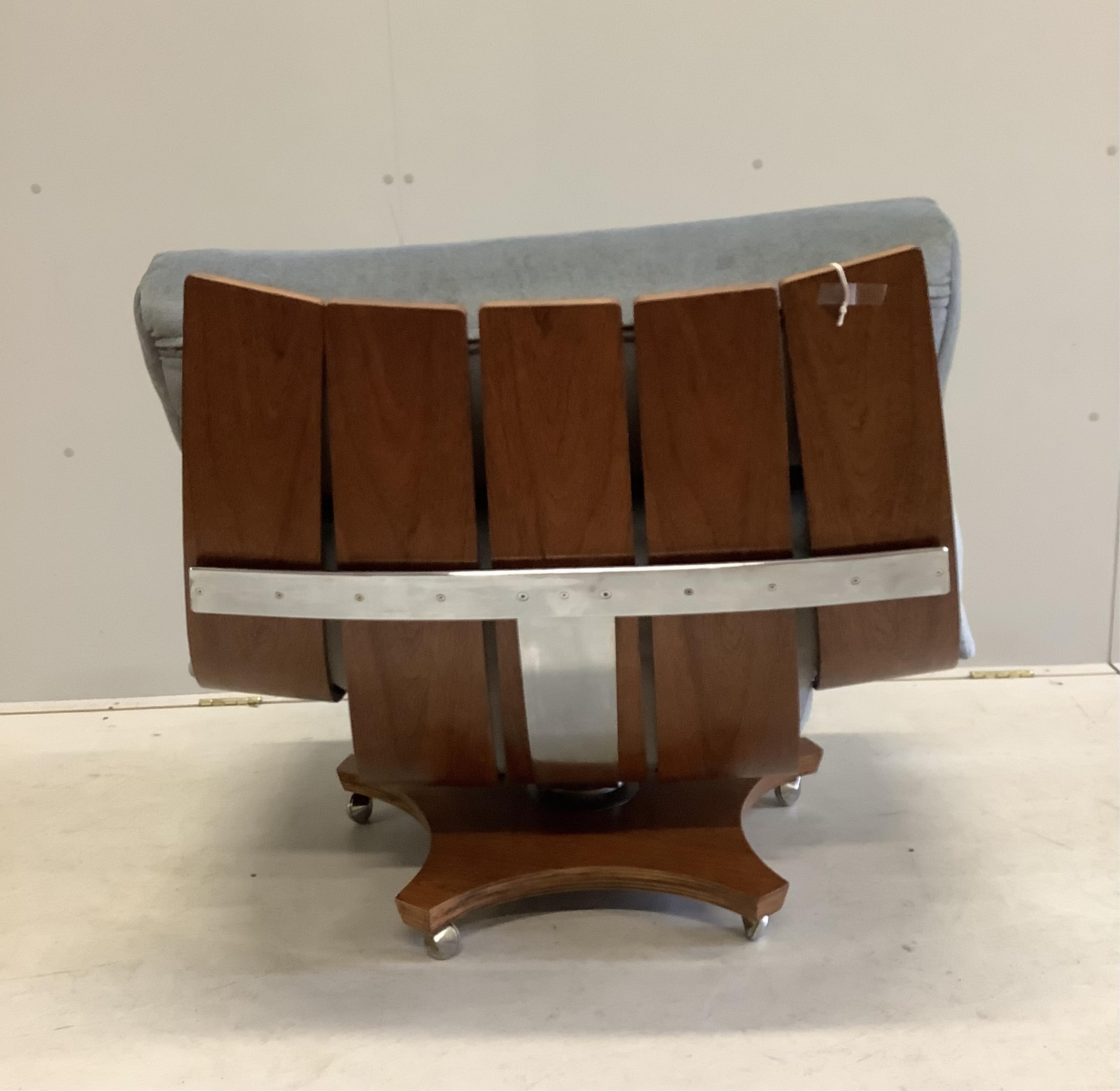 A mid century G Plan Housemaster teak swivel armchair with pale blue loose cushions, width 88cm, depth 66cm, height 81cm. Condition - fair to good